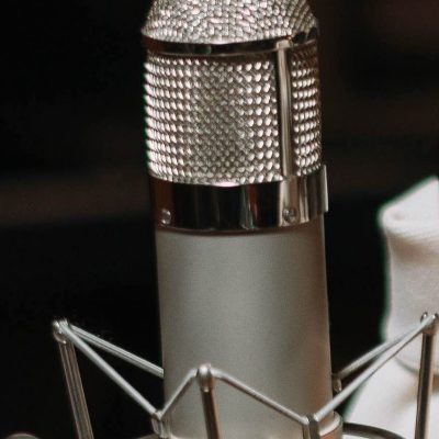 Close up shot of a silver-colored, large capsule tube microphone